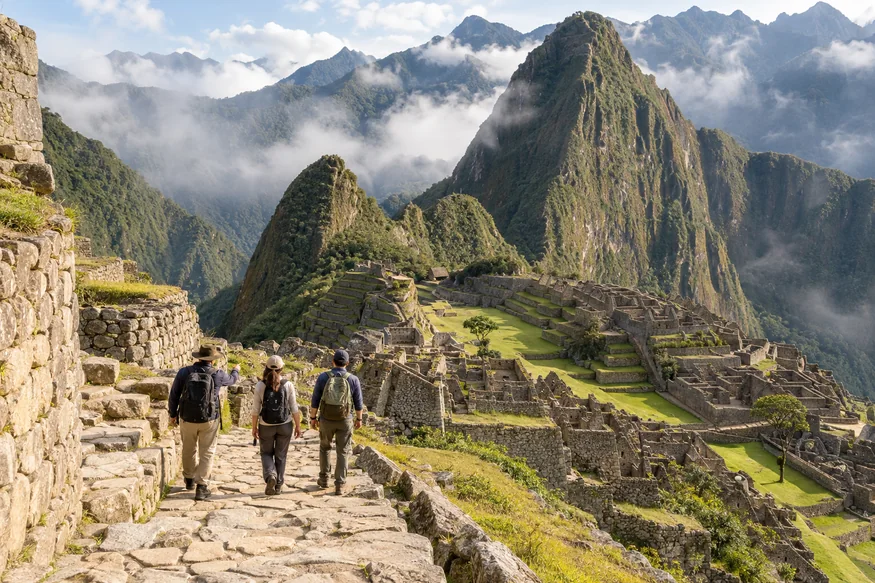 Guide leading travelers through the stone paths of Machu Picchu